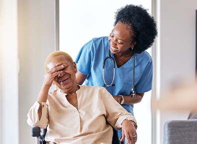Nurse pushing woman in wheelchair